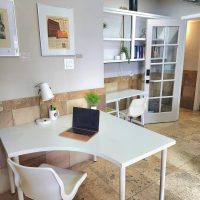 Private office for 1-2 people with access to patio. Private office showing two desks with chairs.